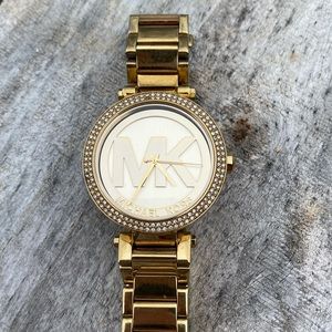 Women’s Michael Kors stainless steel with rhinestones around face of watch